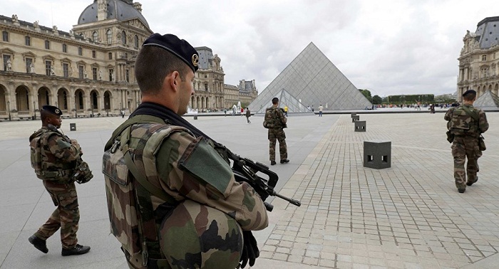 French army soldiers patrol near the Louvre Museum Pyramid`s main entrance in Paris